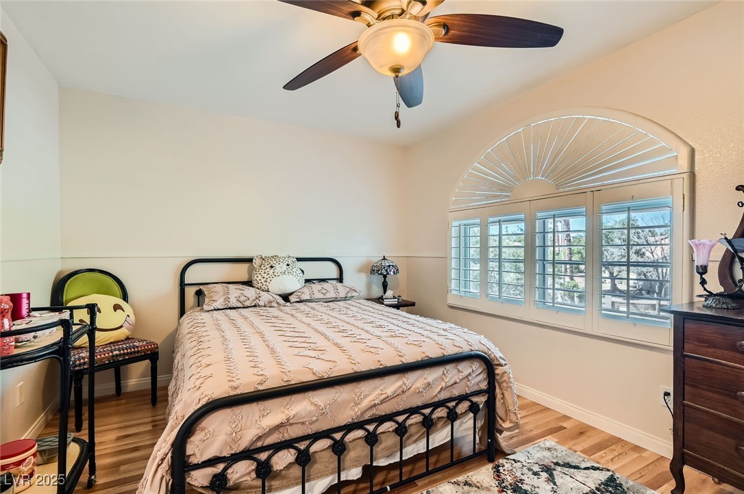 20 High Sierra Henderson, NV 89074 - Photo 36 of 53 Bedroom featuring baseboards, wood finished floors, and a ceiling fan