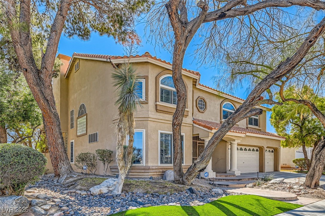 20 High Sierra Henderson, NV 89074 - Photo 4 of 53 Mediterranean / spanish-style home with stucco siding, a tiled roof, and concrete driveway