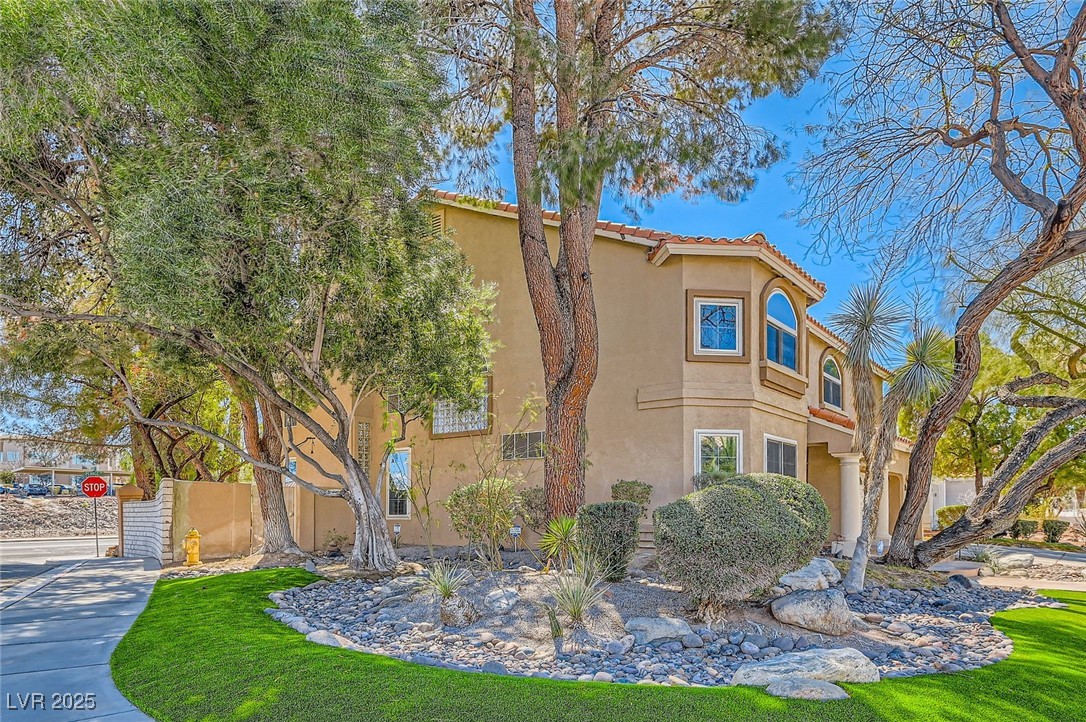 20 High Sierra Henderson, NV 89074 - Photo 5 of 53 View of property exterior with a tiled roof, fence, and stucco siding