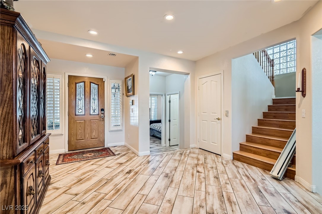 20 High Sierra Henderson, NV 89074 - Photo 8 of 53 Entrance foyer featuring wood finish floors, stairway, a wealth of natural light, and recessed lighting