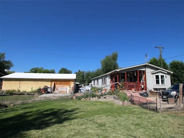 a view of a house with a yard and sitting area