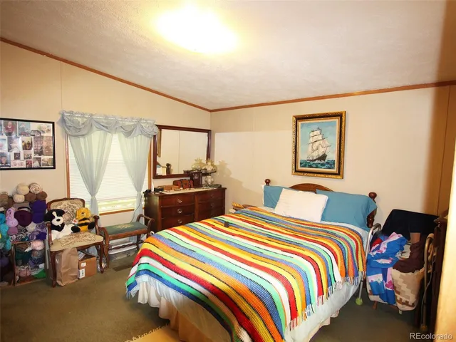 a bedroom with two beds and a desk