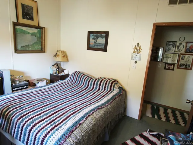 a bedroom with bed and balcony