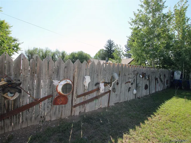 a backyard of a house with table and chairs
