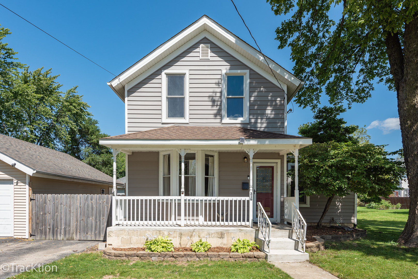 316 East Division Street Lockport, IL 60441 - Photo 1 of 19 a front view of a house with a garden and yard