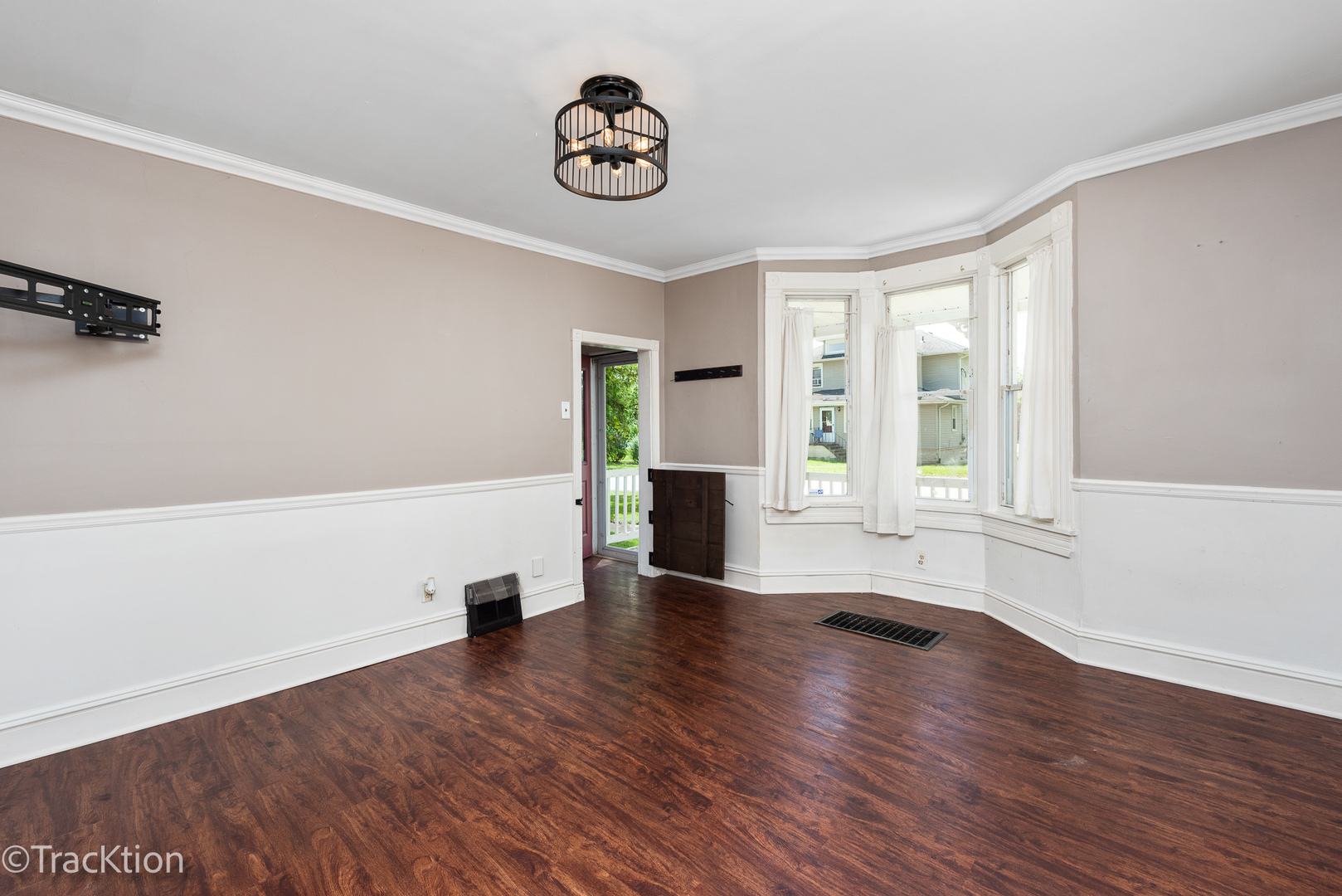 316 East Division Street Lockport, IL 60441 - Photo 3 of 19 a view of an empty room with wooden floor and a window