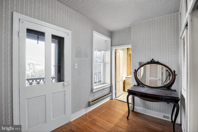 a view of a livingroom with furniture and a window