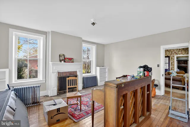 an empty room with windows and closet