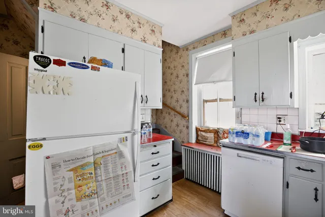 a kitchen with a refrigerator and a sink