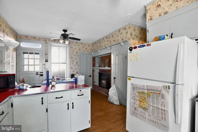 a view of room with wooden floor and ceiling fan