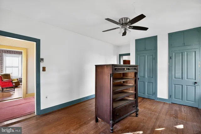 a view of a livingroom with wooden floor and a window