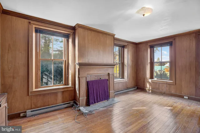 a kitchen with cabinets a sink dishwasher and a stove with wooden floor