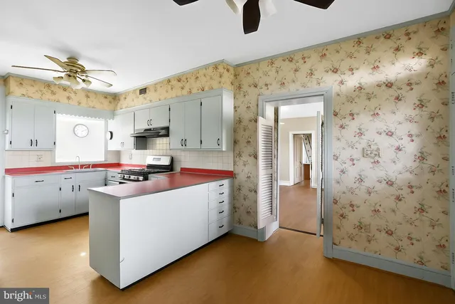 a kitchen with stainless steel appliances kitchen island granite countertop a sink and cabinets