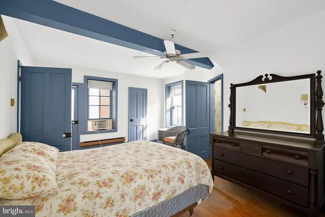 a bedroom with a bed and a mirror