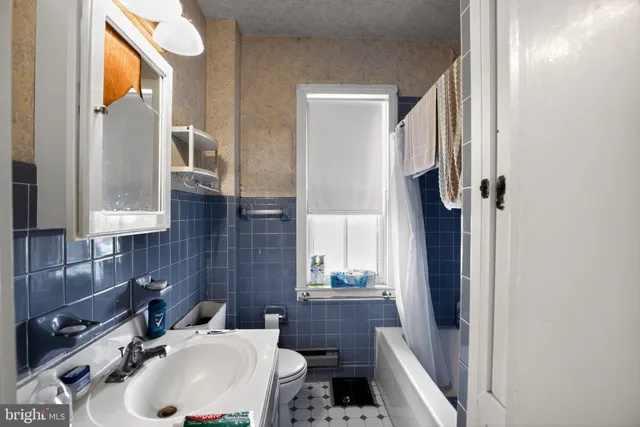 a view of a hallway with furniture and windows