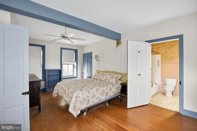 a view of room with wooden floor and ceiling fan
