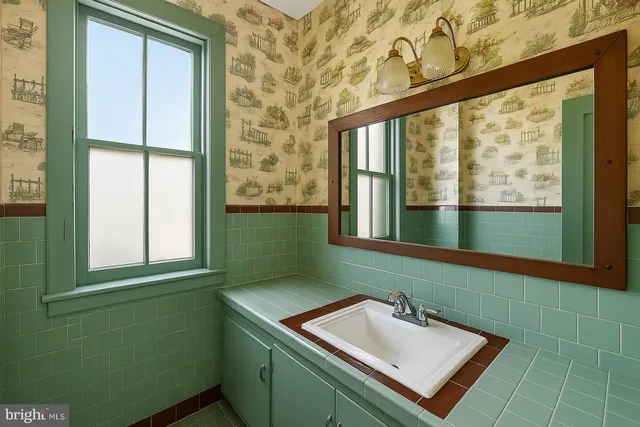 a view of a hallway with furniture and windows