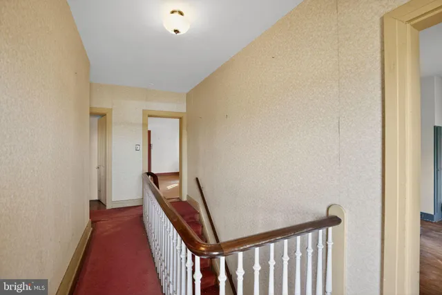 a living room with hardwood floor and large window