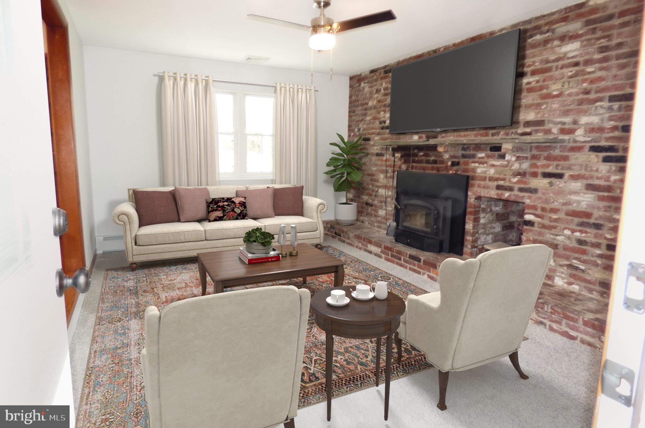 151 Washington Street Red Hill, PA 18076 - Photo 14 of 20 a living room with furniture a fireplace and a flat screen tv
