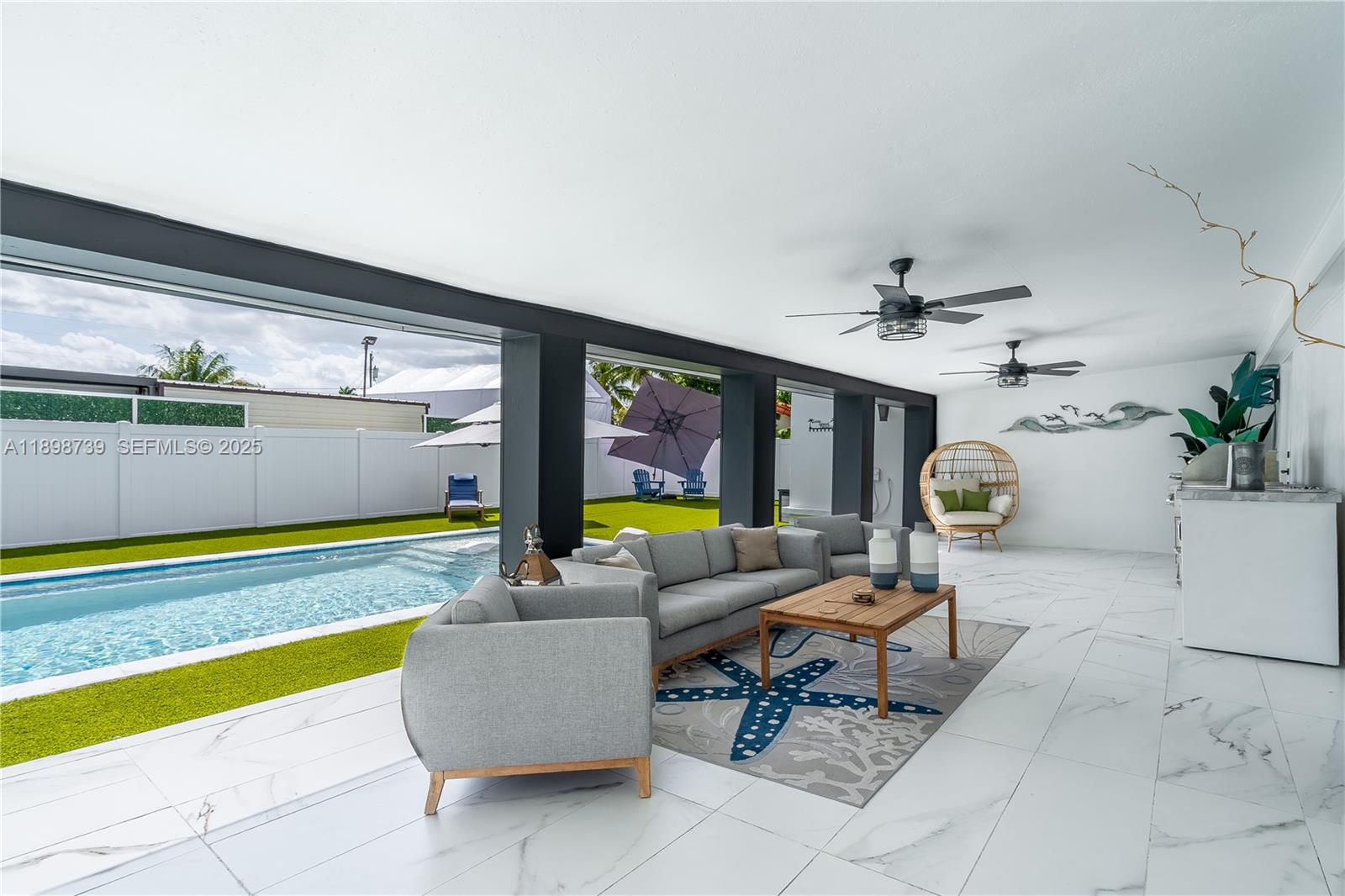 a living room with furniture and floor to ceiling window
