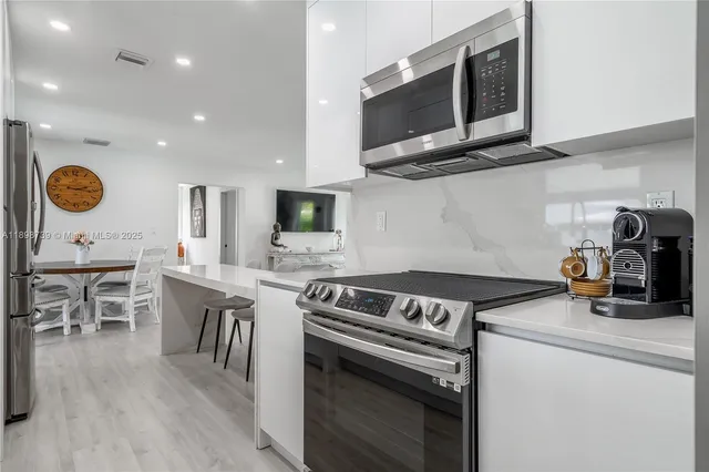a kitchen with a stove and a microwave