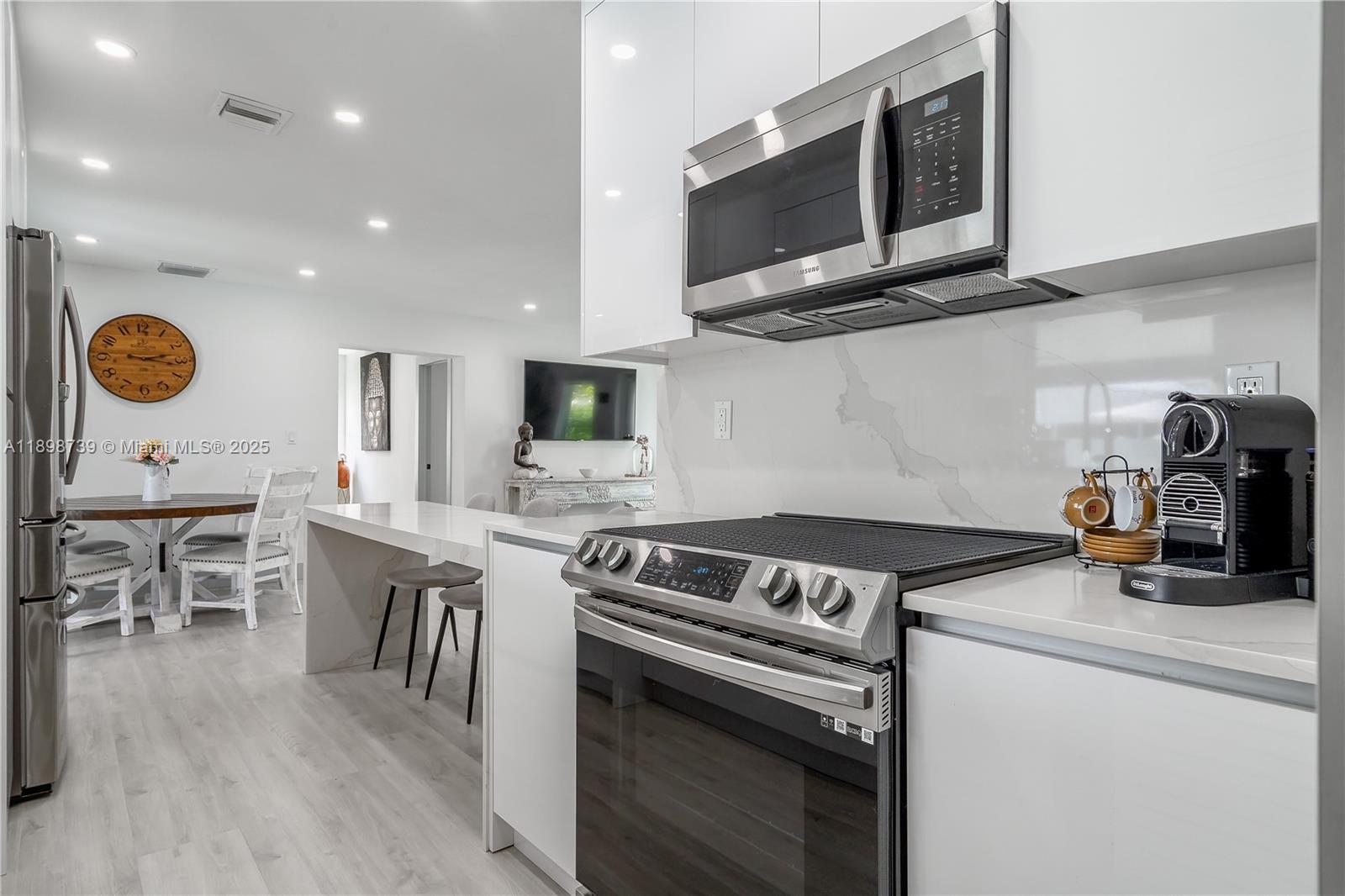 11350 Southwest 57th Street Miami, FL 33173 - Photo 11 of 47 a kitchen with a stove and a microwave