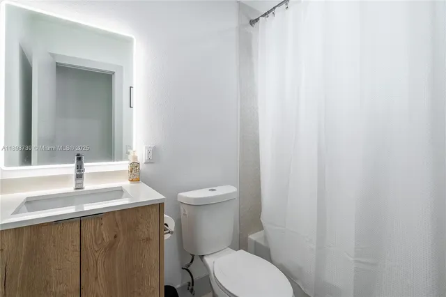 a white toilet sitting next to a sink