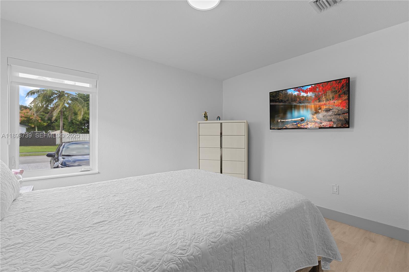 11350 Southwest 57th Street Miami, FL 33173 - Photo 22 of 47 a bedroom with a bed and a painting on the wall