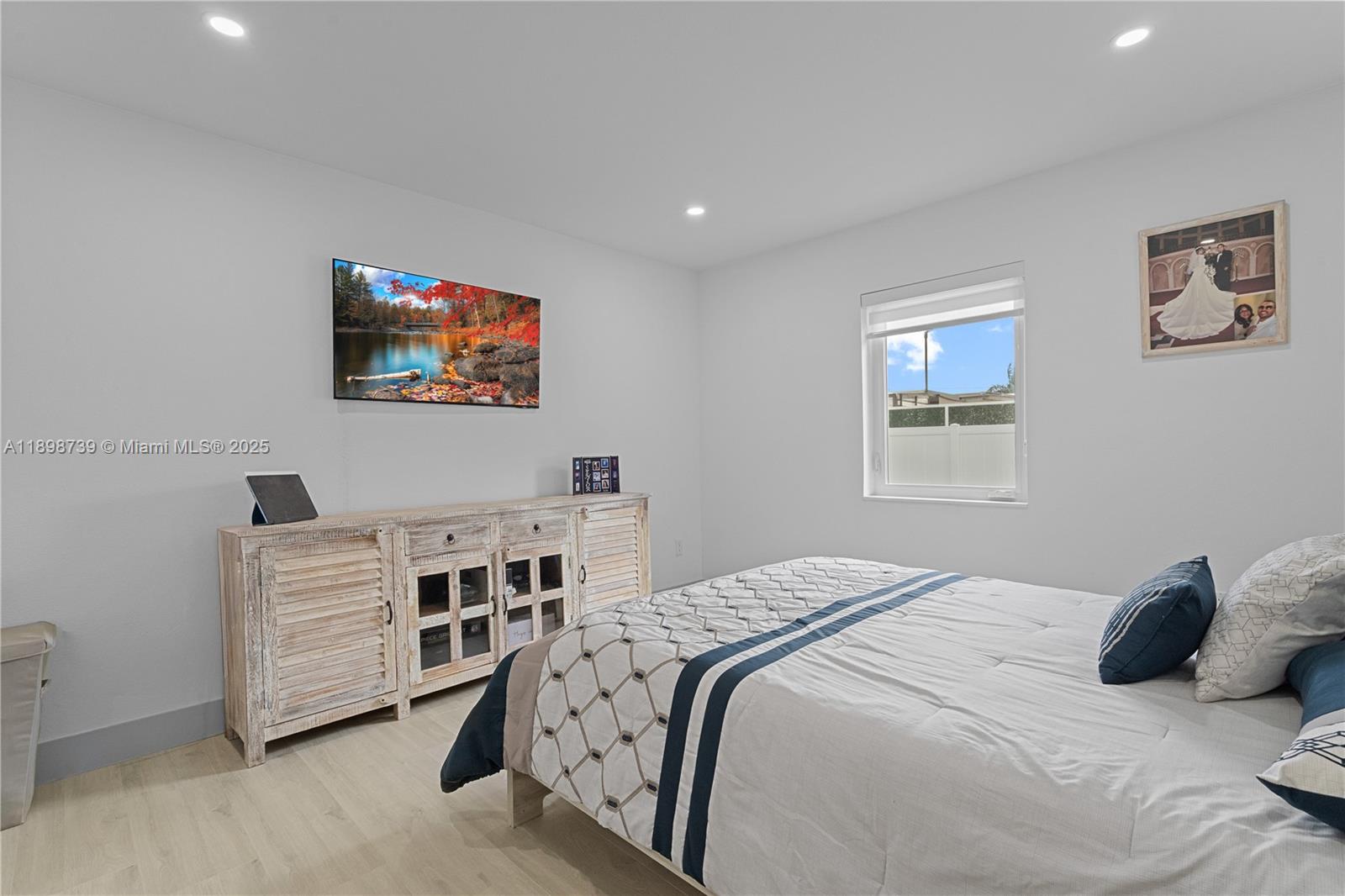 11350 Southwest 57th Street Miami, FL 33173 - Photo 28 of 47 a bedroom with a bed and a flat screen tv