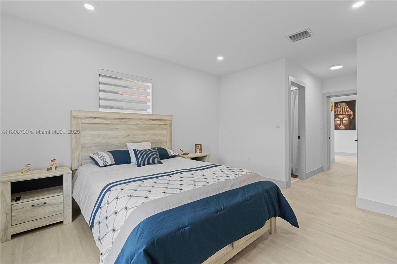 11350 Southwest 57th Street Miami, FL 33173 - Photo 29 of 47 a bedroom with a bed and a night stand