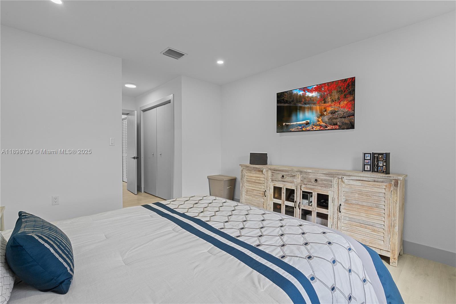 11350 Southwest 57th Street Miami, FL 33173 - Photo 30 of 47 a bedroom with a bed and a flat screen tv