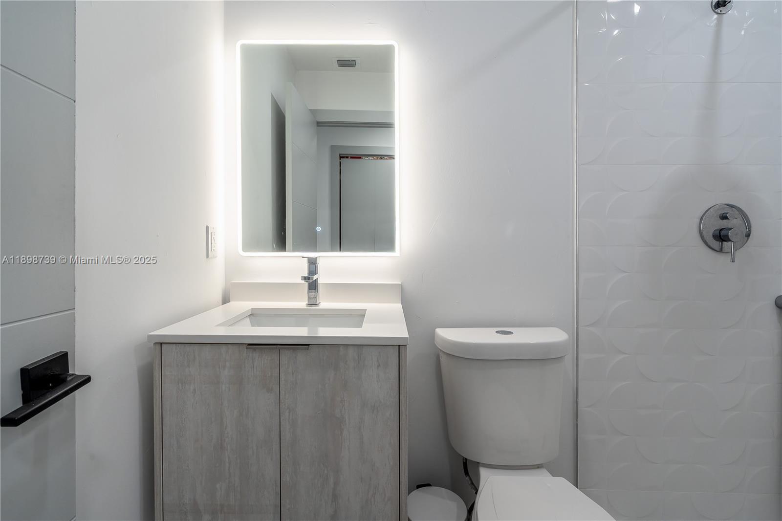 11350 Southwest 57th Street Miami, FL 33173 - Photo 31 of 47 a bathroom with a granite countertop toilet sink and mirror