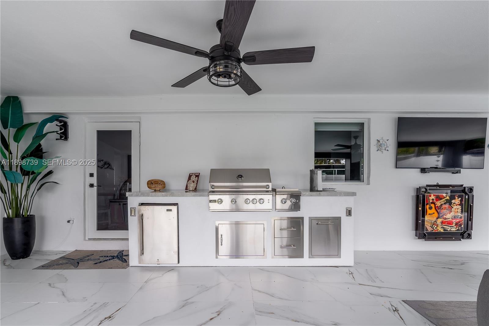 11350 Southwest 57th Street Miami, FL 33173 - Photo 33 of 47 a kitchen with stainless steel appliances a stove a chimney a sink and cabinets