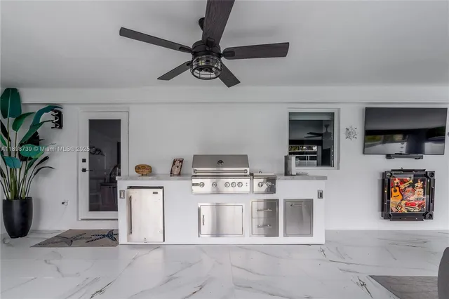 a kitchen with stainless steel appliances a stove a chimney a sink and cabinets