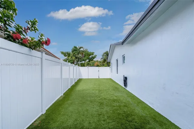a view of a backyard with potted plants