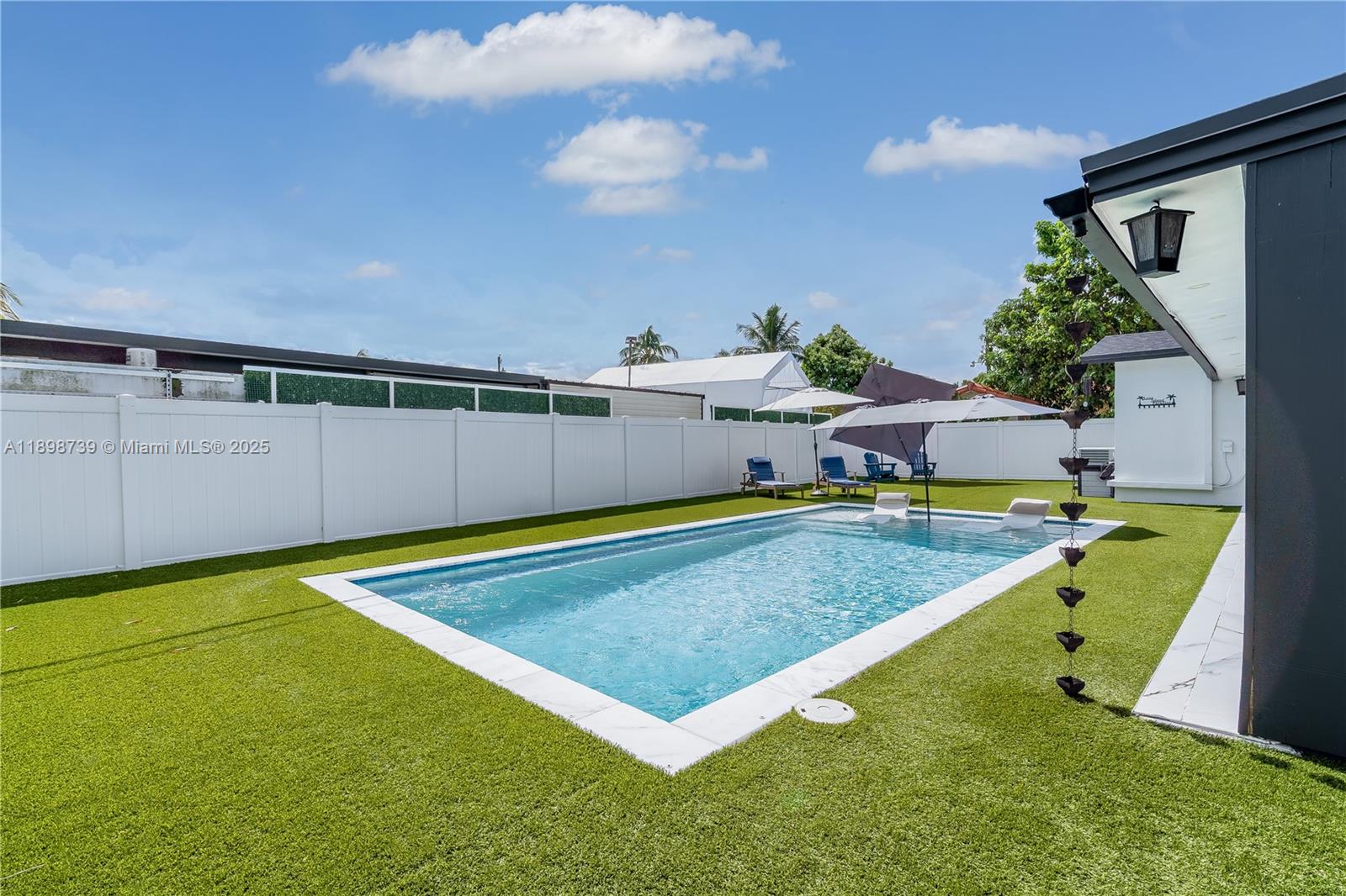 11350 Southwest 57th Street Miami, FL 33173 - Photo 37 of 47 a view of a swimming pool with an outdoor seating and yard