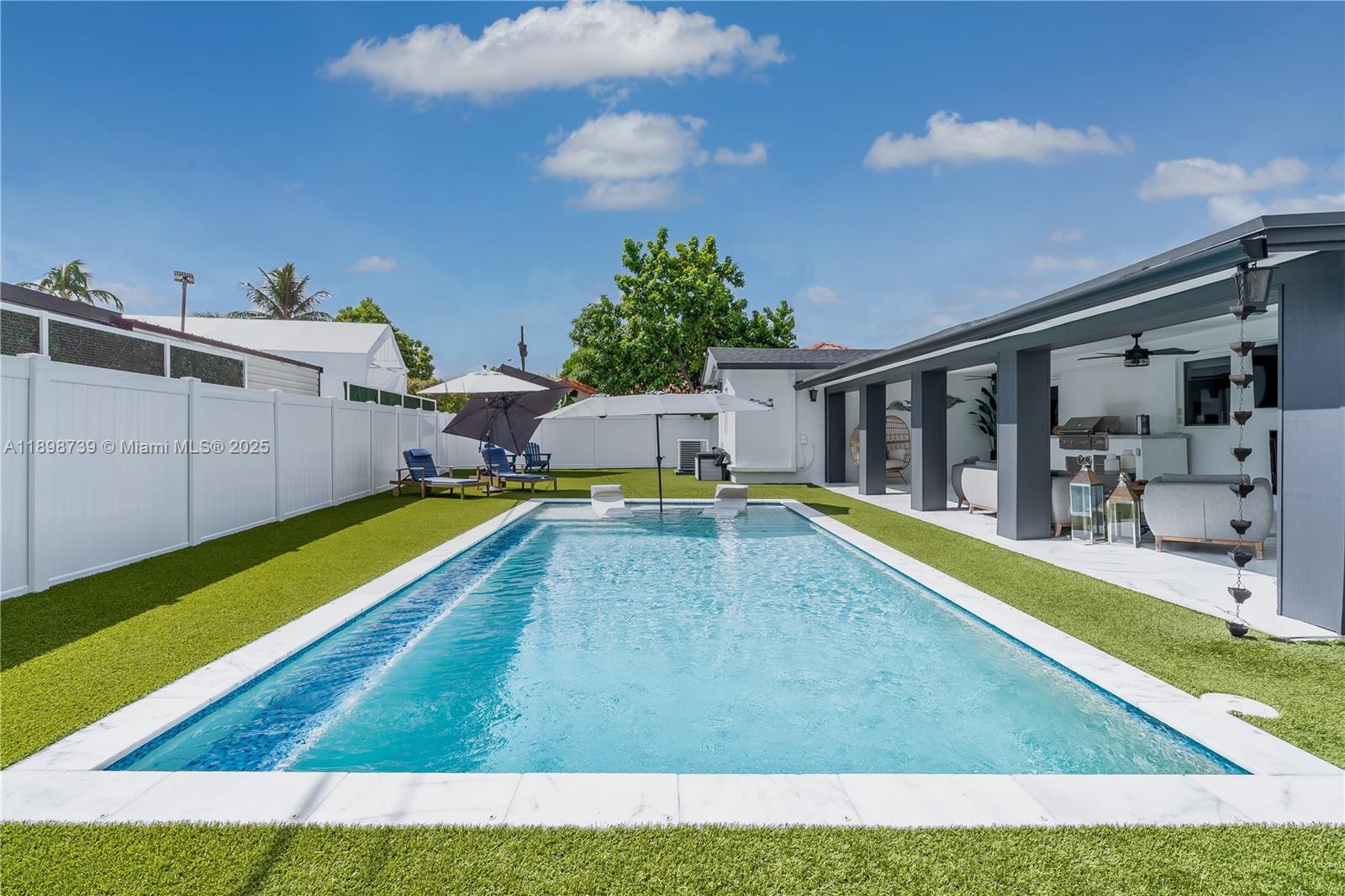 11350 Southwest 57th Street Miami, FL 33173 - Photo 40 of 47 a swimming pool with outdoor seating and yard