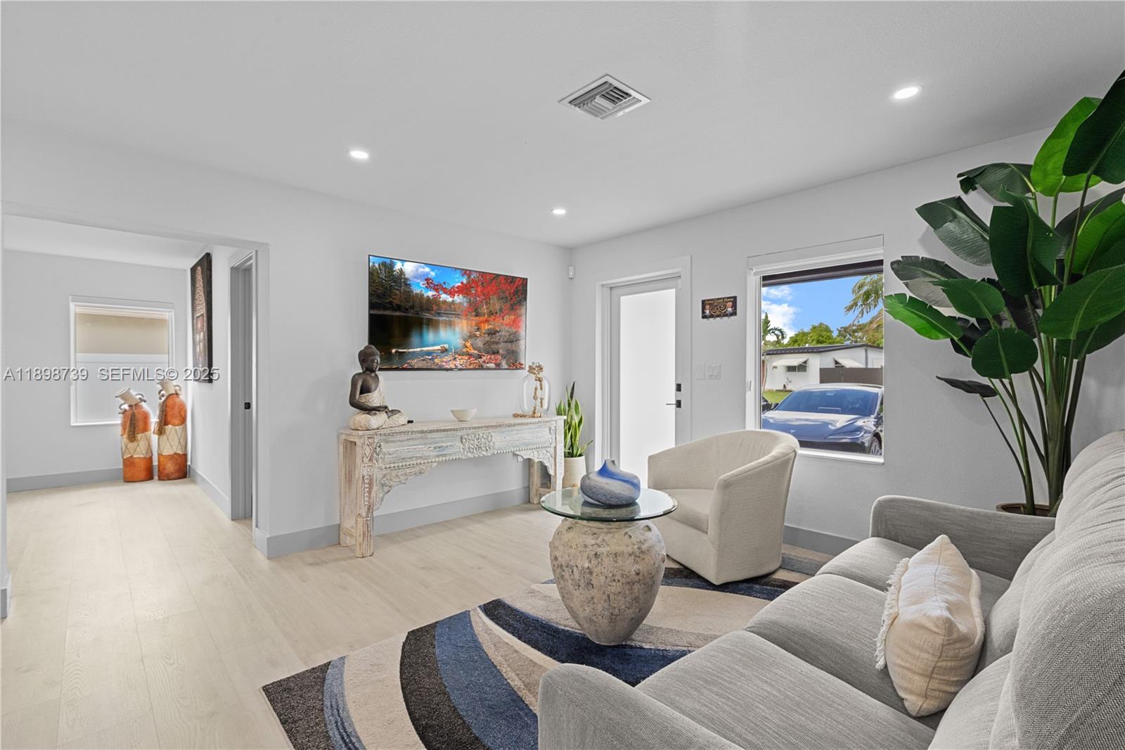 11350 Southwest 57th Street Miami, FL 33173 - Photo 4 of 47 a living room with furniture and a flat screen tv