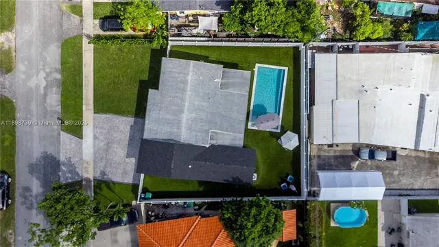 an aerial view of a house with a swimming pool