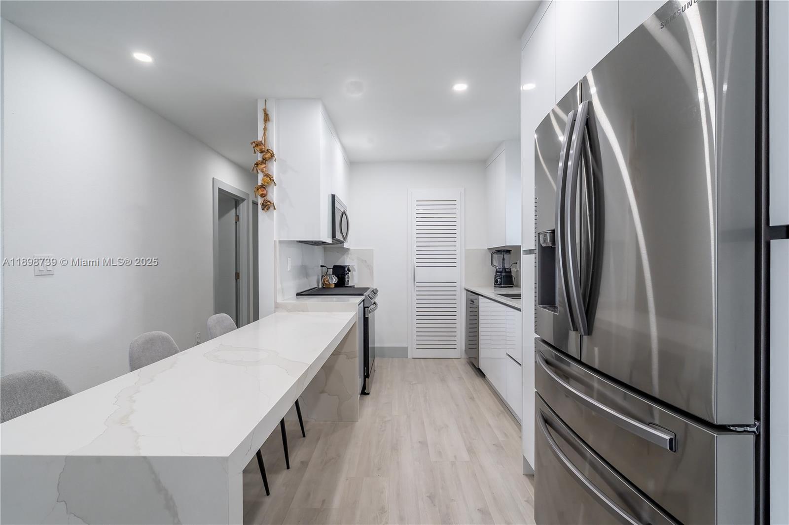 11350 Southwest 57th Street Miami, FL 33173 - Photo 7 of 47 a kitchen with stainless steel appliances a refrigerator and a stove top oven