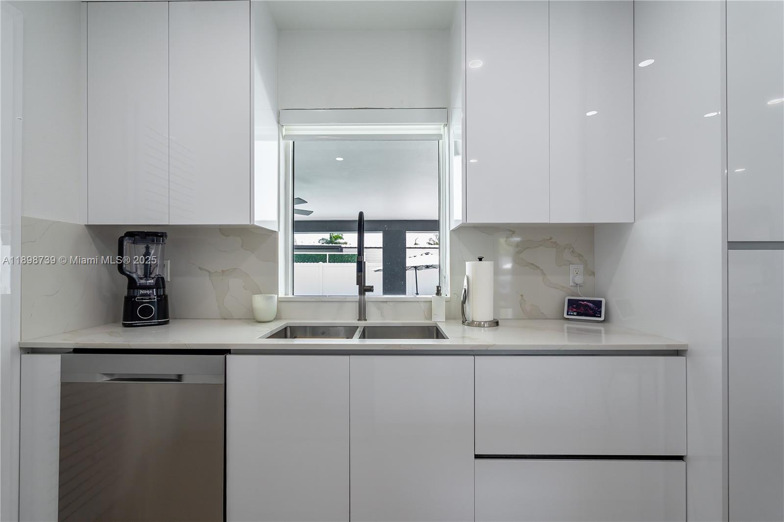 11350 Southwest 57th Street Miami, FL 33173 - Photo 9 of 47 a kitchen with stainless steel appliances granite countertop a sink and a refrigerator