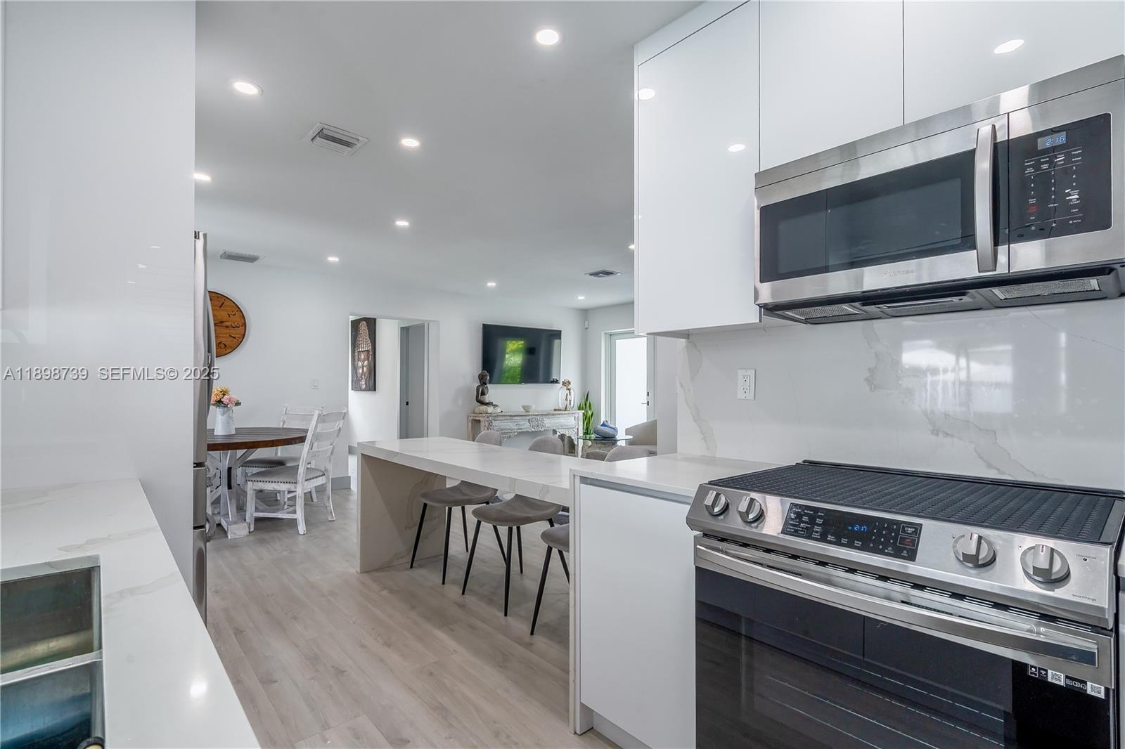 11350 Southwest 57th Street Miami, FL 33173 - Photo 10 of 47 a kitchen with a stove and a microwave