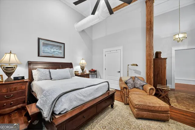 a bedroom with bed couch and window