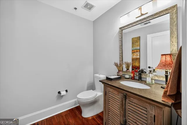 a bathroom with a sink a toilet and mirror