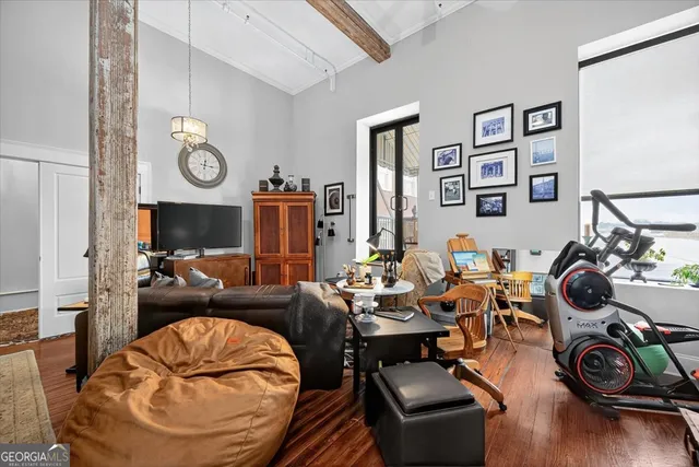 a living room with furniture a rug and a window