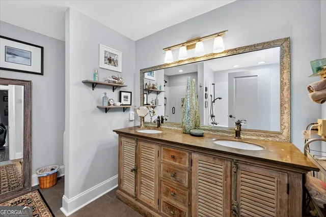 a bathroom with double vanity sink and a mirror