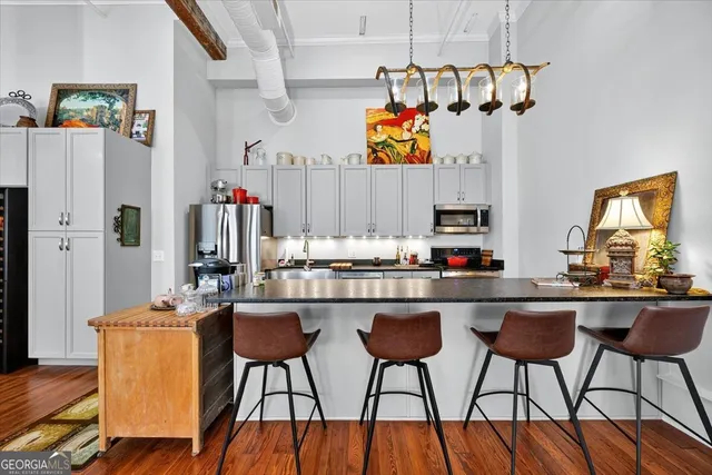 a dining room with furniture and a kitchen view