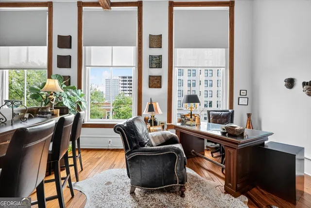 a living room with furniture and a floor to ceiling window