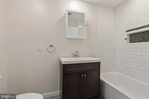 a bathroom with a sink a toilet and bathtub