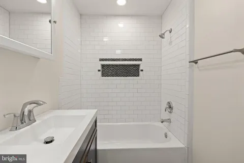 a bathroom with a sink a bathtub and a shower